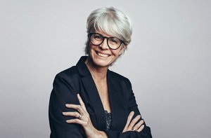 Attractive woman in her 60s with a mid-length feathered haircut